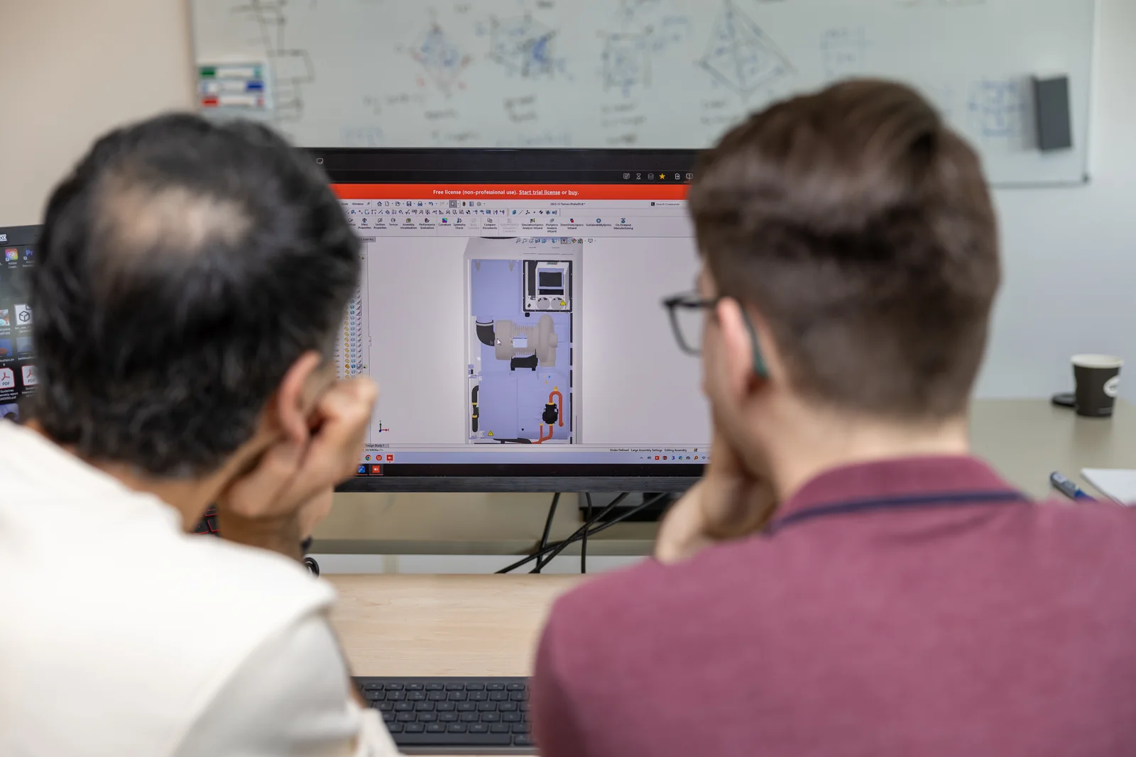 Two Tarnoc engineers reviewing the CAD model of the turbine unit